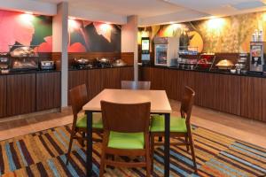 a dining room with a table and chairs at Fairfield Inn & Suites by Marriott Lexington Georgetown/College Inn in Georgetown