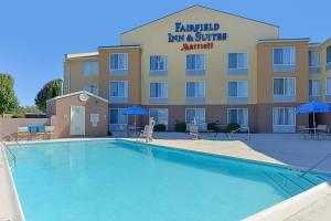 a hotel with a swimming pool in front of a building at Fairfield Inn & Suites by Marriott Lexington Georgetown/College Inn in Georgetown