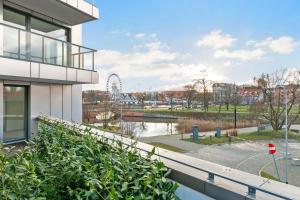 a view from the balcony of a building with a roller coaster at CityFlow by Welcome Apartment in Gdańsk