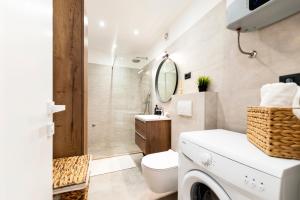 a bathroom with a toilet and a sink and a mirror at Modern and cozy apartments Salt & Pepper in heart of Rovinj in Rovinj +47 photos