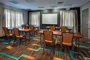 a conference room with tables and chairs and a screen at Residence Inn by Marriott Somerset in Somerset