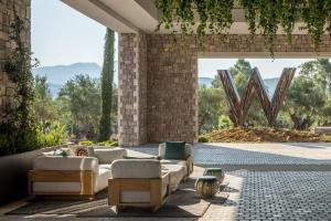 a living room with couches and a large window at W Costa Navarino in Pylos