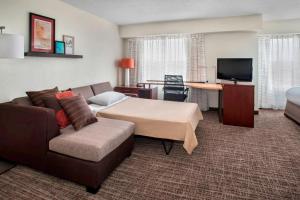 a hotel room with a bed and a couch at Residence Inn by Marriott Somerset in Somerset