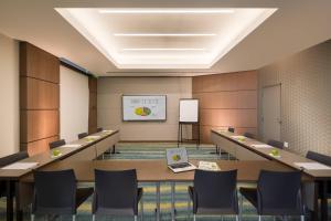 a conference room with tables and chairs and a laptop at Residence Inn by Marriott Miami Beach South Beach in Miami Beach