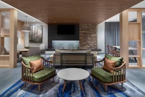 a living room with two chairs and a table at Fairfield Inn & Suites by Marriott Kenosha Pleasant Prairie in Pleasant Prairie