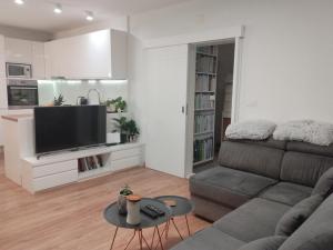 a living room with a couch and a flat screen tv at Luxury apartment near the beach in Makarska