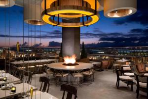 a restaurant with tables and chairs and a fire pit at Courtyard by Marriott San Diego Gaslamp/Convention Center in San Diego