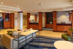 a lobby with a couch and a table and chairs at Fairfield Inn & Suites by Marriott Venice in Venice