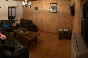 Brione的住宿－Rustico Cà Laura，客厅配有沙发和桌子