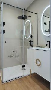 a bathroom with a shower with a glass door at Apartament Gdańska in Gdańsk