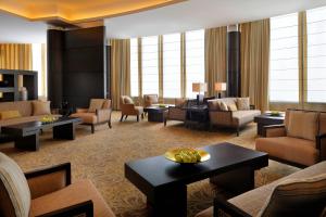 a hotel lobby with couches and tables and chairs at Courtyard Riyadh by Marriott Diplomatic Quarter in Riyadh