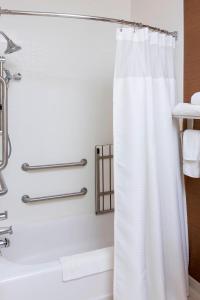 a bathroom with a white shower curtain and a tub at Fairfield Inn & Suites by Marriott Galesburg in Galesburg