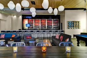 a restaurant with a ping pong table and a pool table at Aloft Durham Downtown in Durham