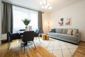 a living room with a couch and a table at Bright stylish apartment in a top location in Vienna
