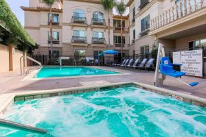 a swimming pool with a chair next to a building at Fairfield Inn & Suites Temecula in Temecula