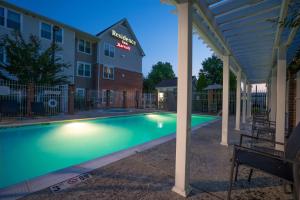 a swimming pool in front of a building at Residence Inn by Marriott Salisbury in Salisbury