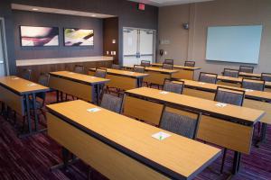 an empty classroom with tables and chairs and a whiteboard at Courtyard by Marriott Omaha East/Council Bluffs, IA in Council Bluffs