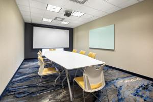a conference room with a white table and chairs at Fairfield Inn & Suites by Marriott Toronto Mississauga in Mississauga
