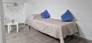 una camera da letto con un letto con cuscini blu di La Perla di Ele a Bari