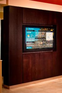 a flat screen tv on a wooden wall at Courtyard Orlando International Drive/Convention Center in Orlando