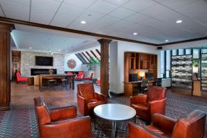 a lobby with leather chairs and a living room at Four Points by Sheraton Manhattan in Manhattan