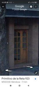 a building with a wooden door on the side of it at Hermoso departamento en Mendoza in Mendoza