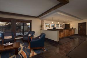 a living room with a bar and some chairs at Marriott's StreamSide Birch at Vail in Vail