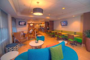 a waiting room with colorful furniture and tables and chairs at Fairfield Inn & Suites By Marriott Jupiter in Jupiter