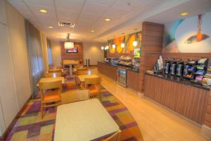 a dining room with tables and chairs in a restaurant at Fairfield Inn & Suites By Marriott Jupiter in Jupiter