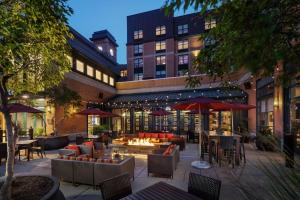 un patio al aire libre con mesas, sillas y una hoguera en Residence Inn Minneapolis Downtown at The Depot, en Minneapolis