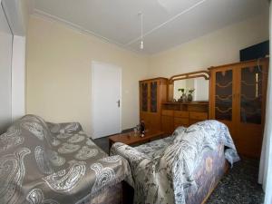 a bedroom with a bed and a dresser and a mirror at Case di Stavros 2 in Pylos