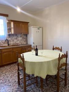 a kitchen with a table with two wine glasses on it at Case di Stavros 2 in Pylos +7 photos