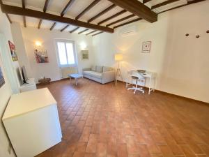 a living room with a couch and a table at BnBetter - Apartment Teddy, near the Train Station to Florence in Prato