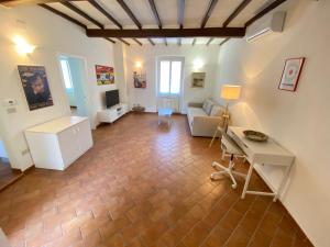 a living room with a couch and a table at BnBetter - Apartment Teddy, near the Train Station to Florence in Prato