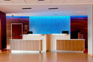 an office lobby with a blue glass wall at Fairfield Inn & Suites by Marriott Des Moines Urbandale in Urbandale
