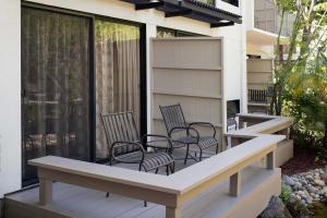 a patio with chairs and tables on a balcony at Sheraton Palo Alto Hotel in Palo Alto