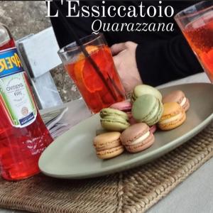a plate of cookies on a table with a drink at L'Essiccatoio in Fivizzano