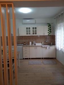 A kitchen or kitchenette at Apartman 2023