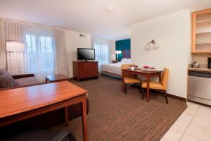 a hotel room with a kitchen and a bedroom at Residence Inn by Marriott San Antonio North Stone Oak in San Antonio