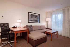 a living room with a couch and a desk at Residence Inn by Marriott San Antonio North Stone Oak in San Antonio