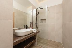 a bathroom with a white sink and a shower at NEW!Beautiful modern bedrooms and apt Old town Zadar- Great location in Zadar