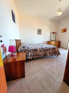 a bedroom with a bed and a table in a room at Villa S.Antonio in Ascea