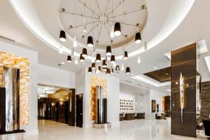 a lobby with a large ceiling with a chandelier at The Davenport Grand, Autograph Collection in Spokane