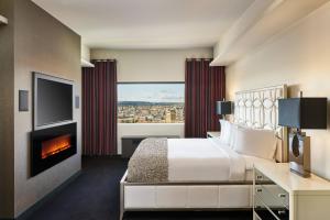 a hotel room with a bed and a fireplace at The Davenport Grand, Autograph Collection in Spokane