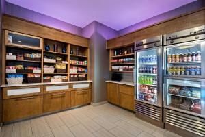 a grocery store aisle with an open refrigerator at SpringHill Suites by Marriott San Antonio SeaWorld®/Lackland in San Antonio