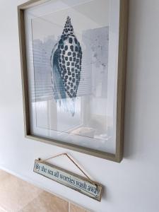 a picture of a bird in a picture frame on a wall at Plain Sailing 2 min walk to the harbour amazing location in Brixham