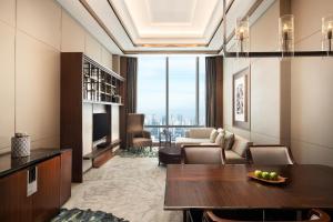 a living room with a dining table and a couch at The Westin Jakarta in Jakarta