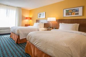 a hotel room with two beds and a window at Fairfield Inn & Suites by Marriott Columbus in Columbus