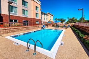 a swimming pool in front of a building at Fairfield Inn & Suites Memphis Olive Branch in Olive Branch