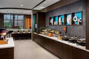 a restaurant with a counter with food on it at SpringHill Suites by Marriott Belmont Redwood Shores in Belmont